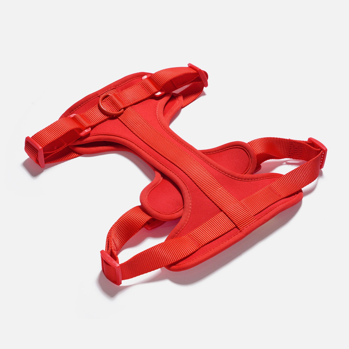Red dog harness on a white background