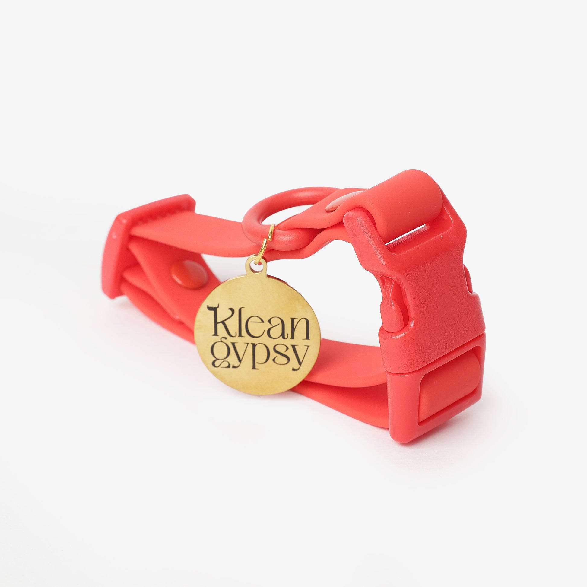 Red dog collar with a gold 'Klean Gypsy' tag on a white background